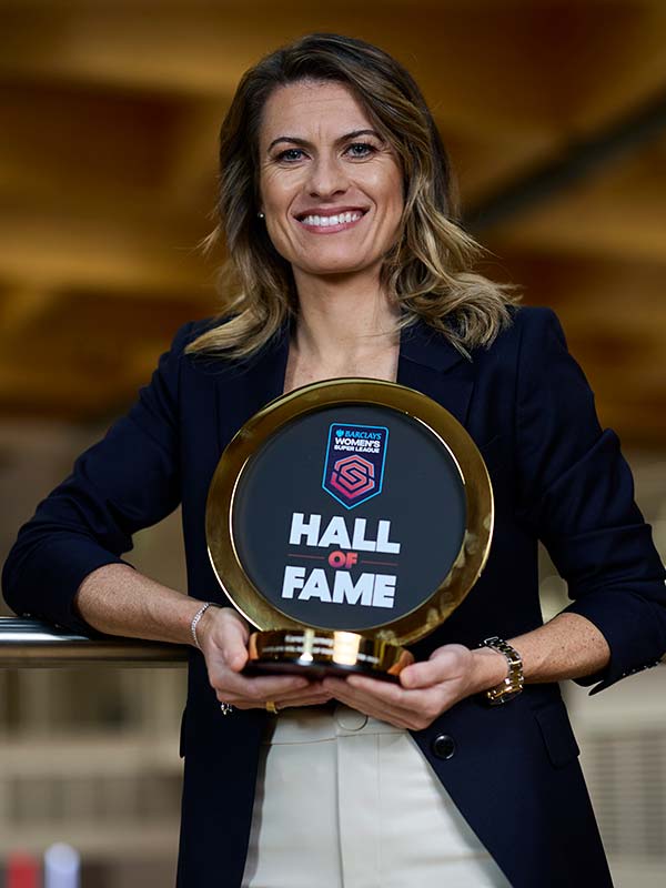 Karen Carney holding a Hall of Fame award.