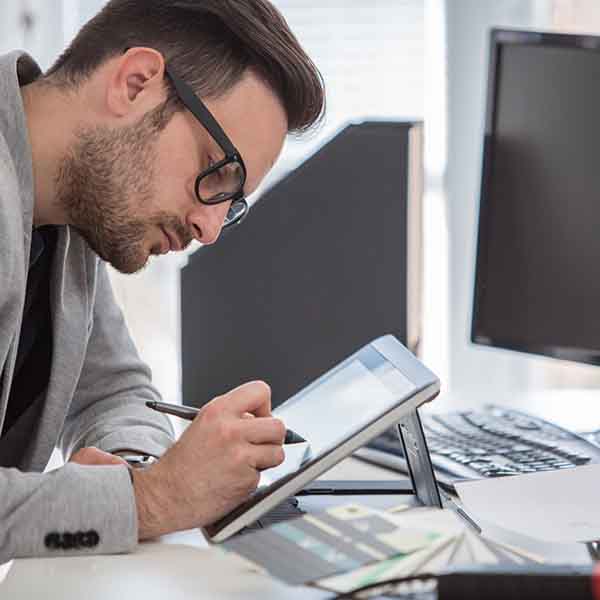 Male working at tablet computer