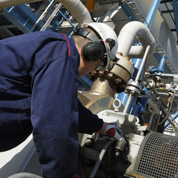 A worker at an industrial chemical plant