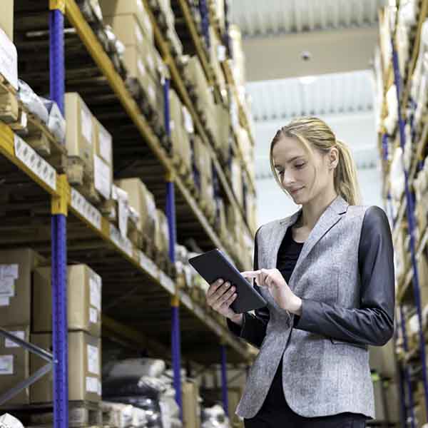 Female with laptop in stock room