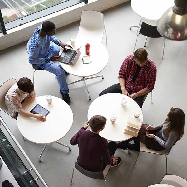 Aerial view of students sitting around coffee tables