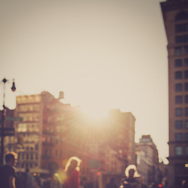 Pedestrians in city at sunset