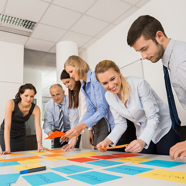 Group of business people discussing notes on table