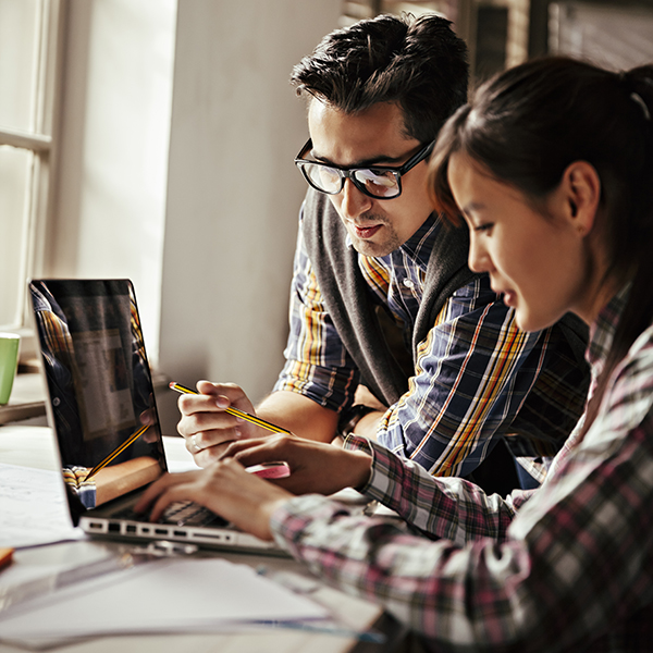 Male and female using laptop