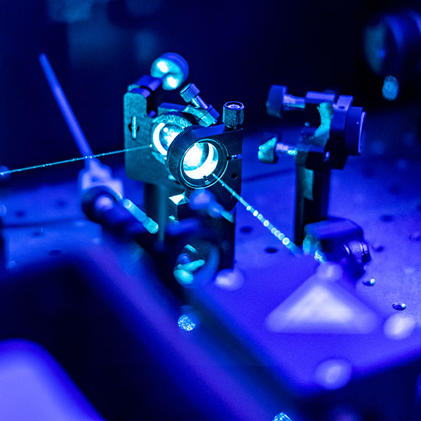 Laser reflecting on optic table in quantum laboratory
