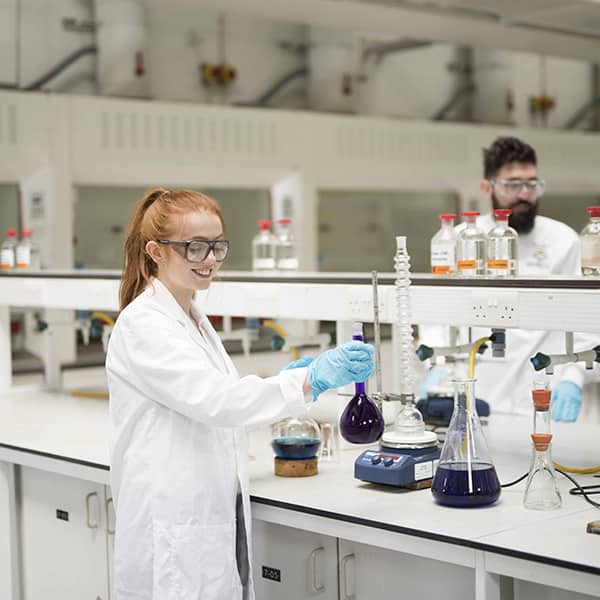 Students conducting experiments in lab.