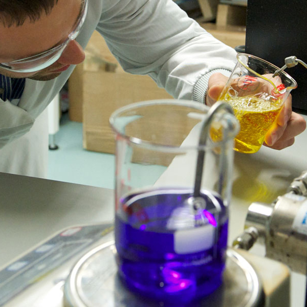 Laboratory beakers testing coloured liquids