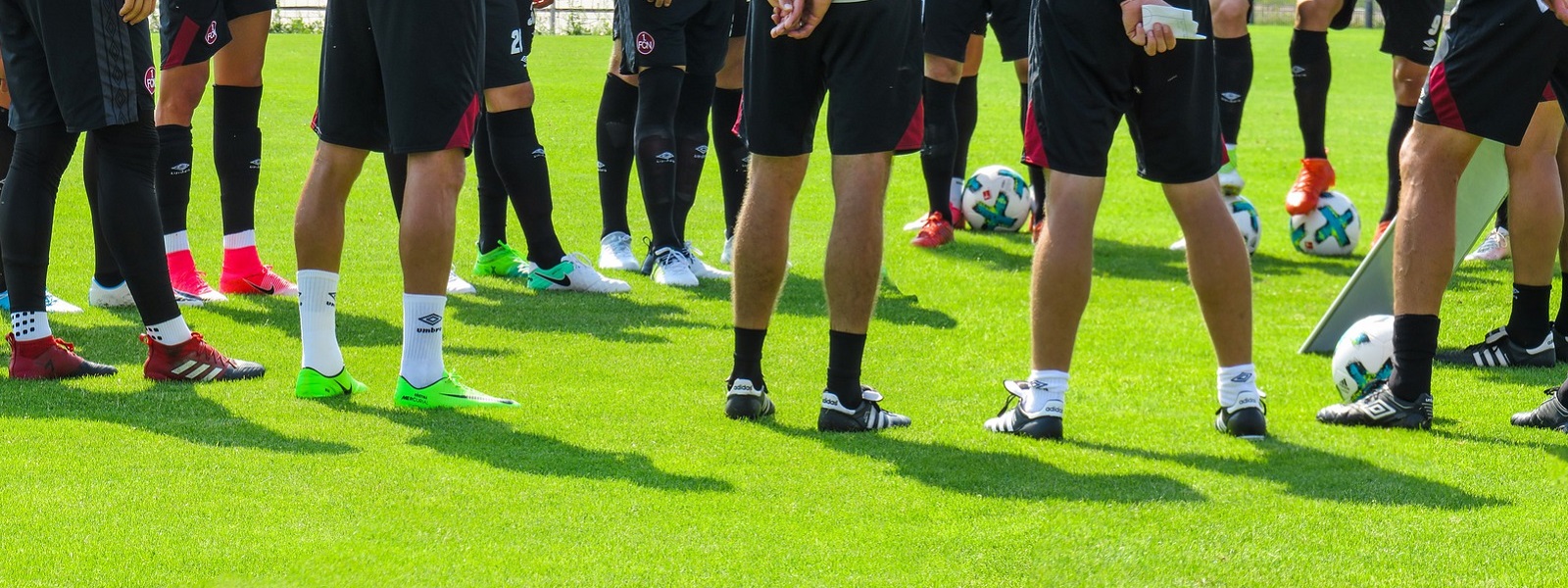 Legs of a group of footballers standing