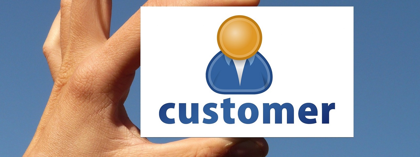 A hand holding a card that says 'customer'