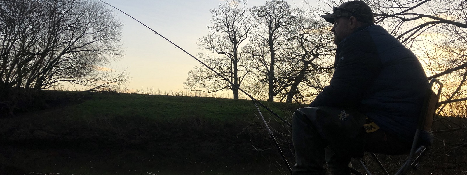 Man fishing at a river bank