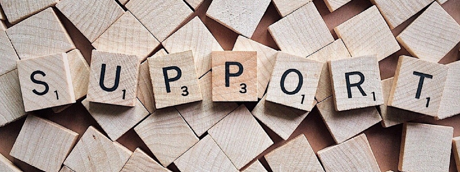 Scrabble tiles spelling the word 'support'