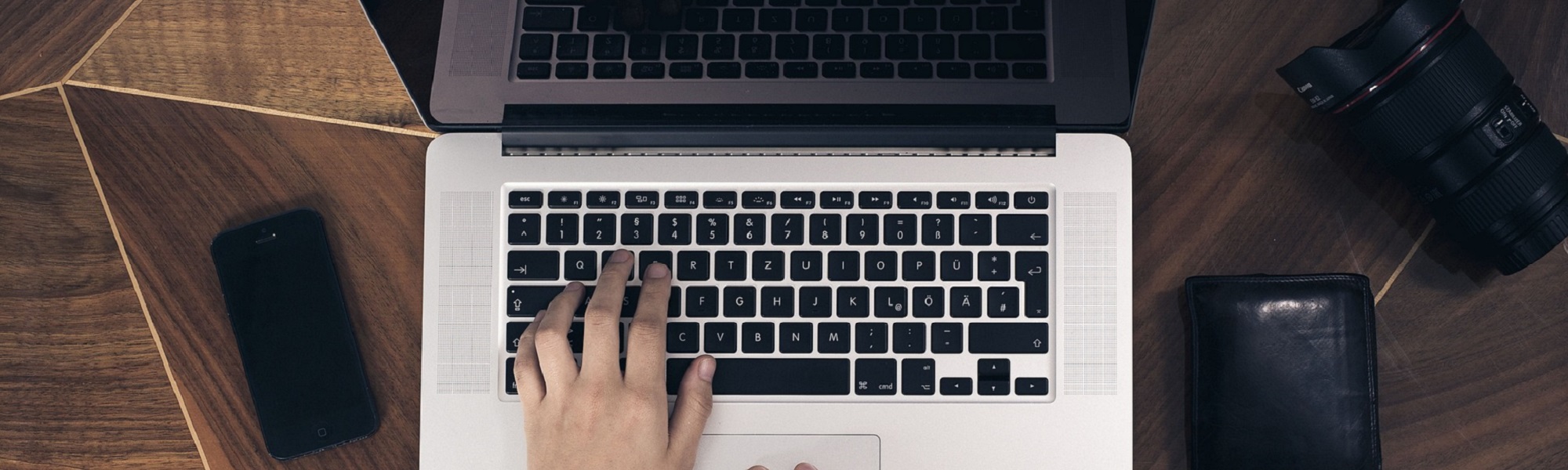 A hand typing on a laptop keyboard
