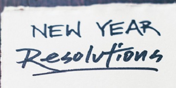 A piece of paper that says 'New Year Resolutions' A piece of paper that says 'New Year Resolutions'