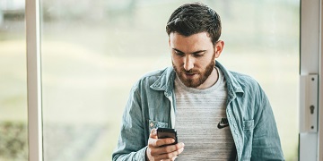 A man looking at a mobile phone A man looking at a mobile phone