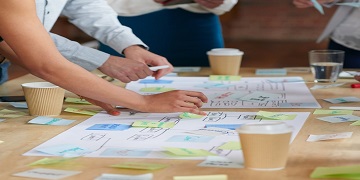 Hands working on a document on a table