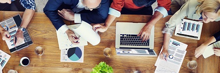 A bird's eye view of people working around a desk