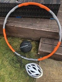 A hula hoop, skipping ropes, basketball, and bike helmet