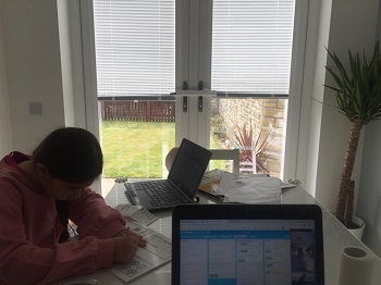 Susan's daughter working alongside her at the dining table