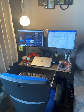 An office desk set up with monitors and a keyboard
