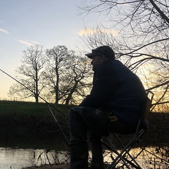 My trusty guide, fishing at the river bank