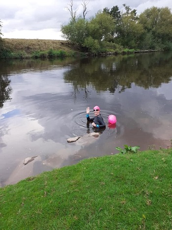 Susan Hillis in a river wearing a wet-suit and swim cap