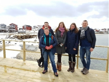 A group photo of Svein, John and 3 others standing on a jetty in Norway