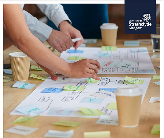 Hands writing on sticky notes and paper with the University of Strathclyde logo on the top right