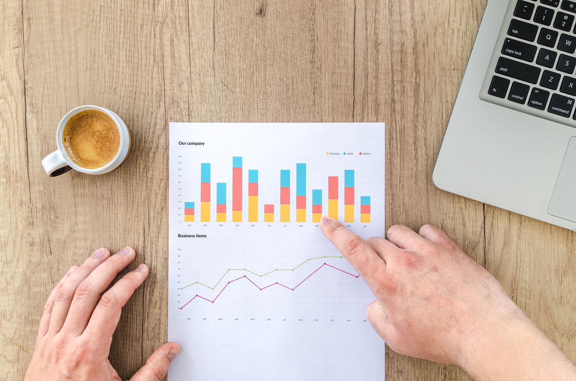 person looking at a print out of a bar graph