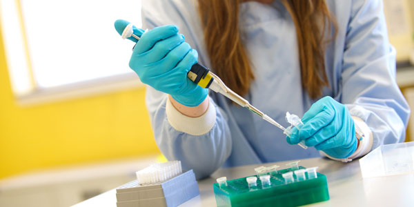 a researcher injecting a sample into small containers