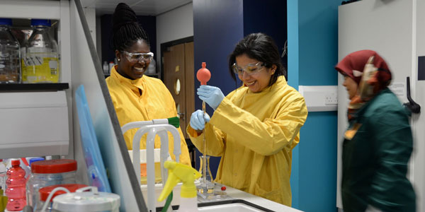 two female students carrying out an experiment in a lab