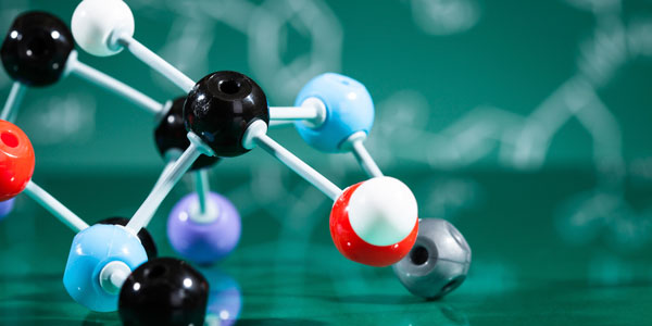 a 3D molecular structure sitting on a green surface