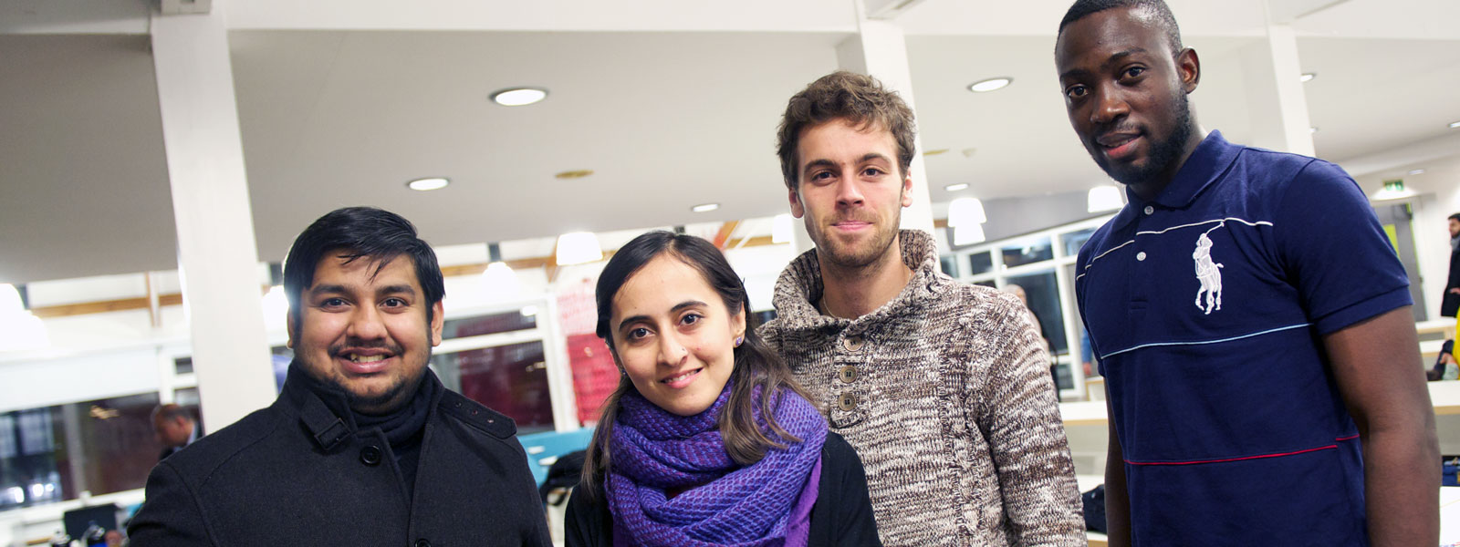 Four international students posing for a photograph at the Interfaith Dinner