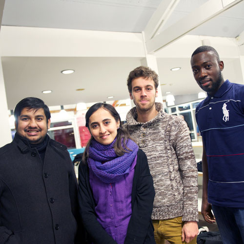 Four international students posing for a photograph at the Interfaith Dinner