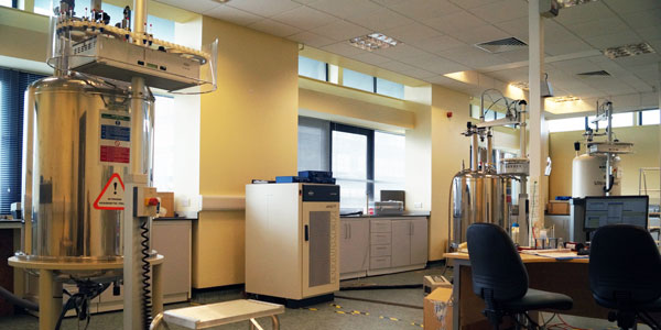 a big silver tank sits in a chemistry lab with computer facilities for analysing data