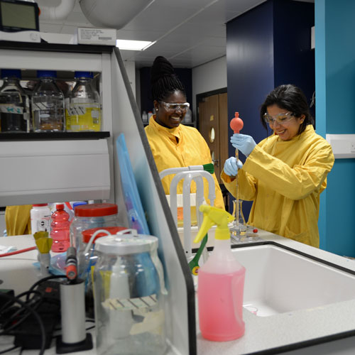 two female students carrying out an experiment