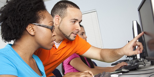 Students working around computer screen