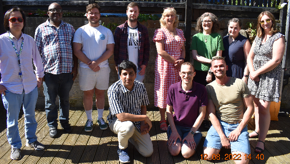 11 members of the StrathCyber research group posing for a group photo in the sunshine.