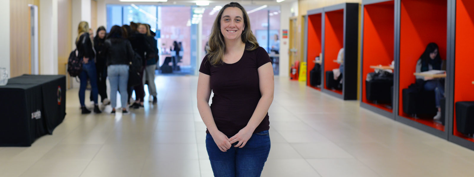 MSc student Michelle standing in the Business School smiling at the camera