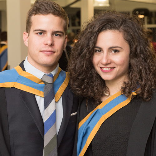 Male and female student at graduation