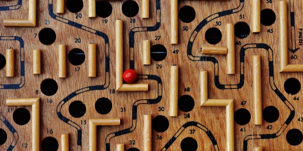 Wooden labyrinth with red ball