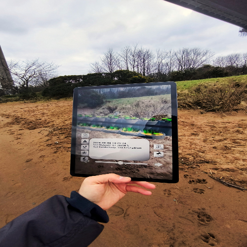 Hand holding an ipad that is scanning the ground