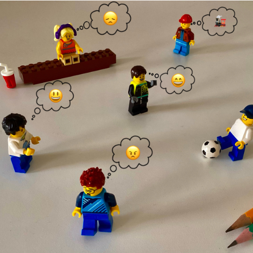 Lego figures playing with emojis above their heads