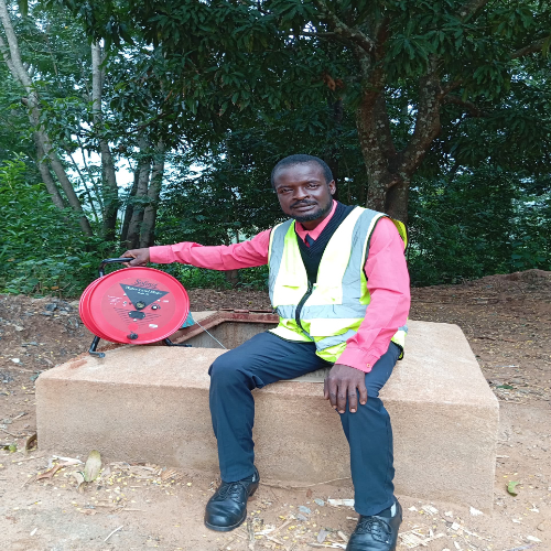 Man sitting on a well with high visibility vest on