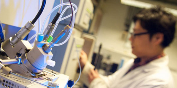 student working in lab with technical equipment