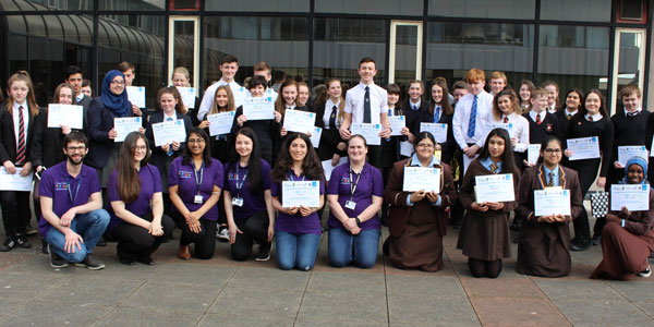 Young Chemical Ambassadors programme participants hold their certificates and smile at the camera