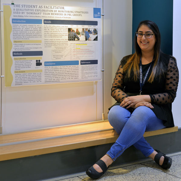 PhD student Aditi sitting and smiling at the camera