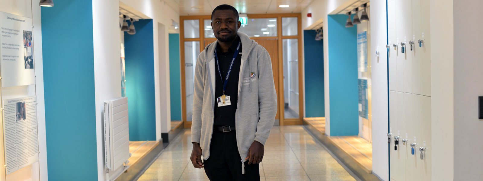 Chemical Engineering PhD student Precious standing in the corridor of the Department of Chemical and Process Engineering smiling at the camera 