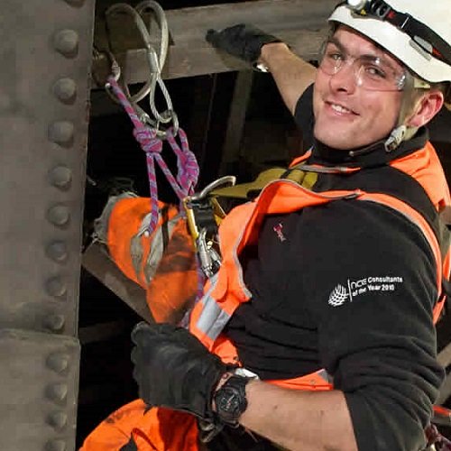 civil engineer in hard hat in a harness