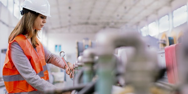 a female engineer works in a factory