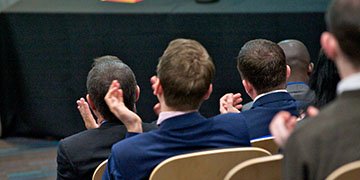 Delegates clapping at a conference